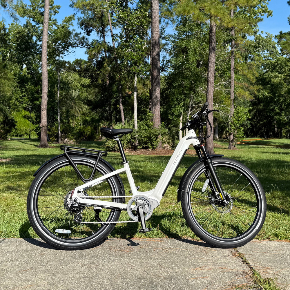 Lunar white step-through Dremax parked on a paved park path with its low frame visible.