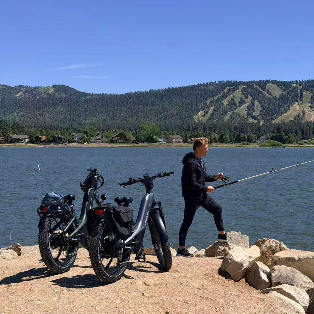 Two loaded Nomad Pro e-bikes parked beside a lake during a weekend ride.