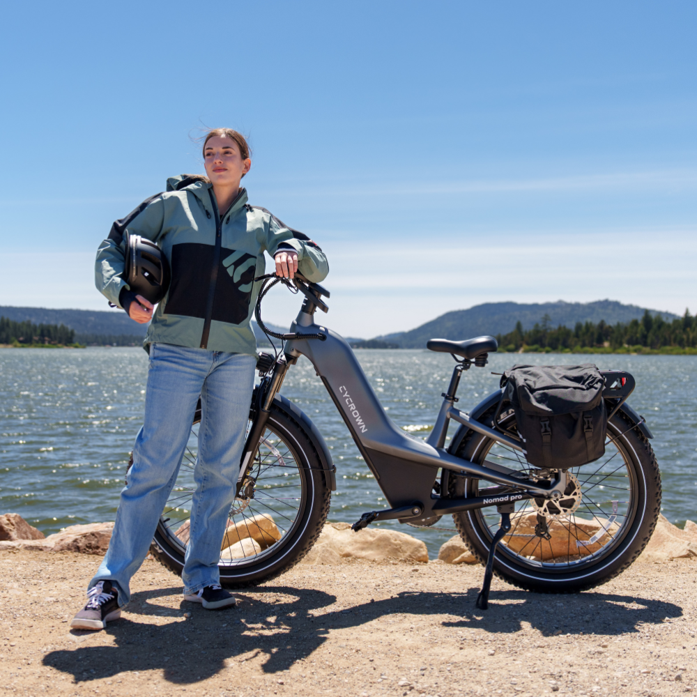 Nomad Pro with rear cargo by a mountain lake, showing the bike's touring and weekend-ride setup.