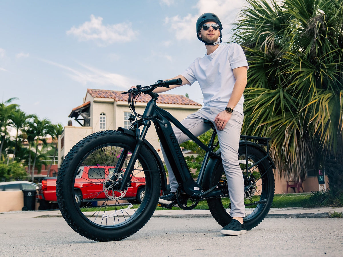Rider on a silver Velowave Ranger 2.0 fat-tire electric bike outdoors