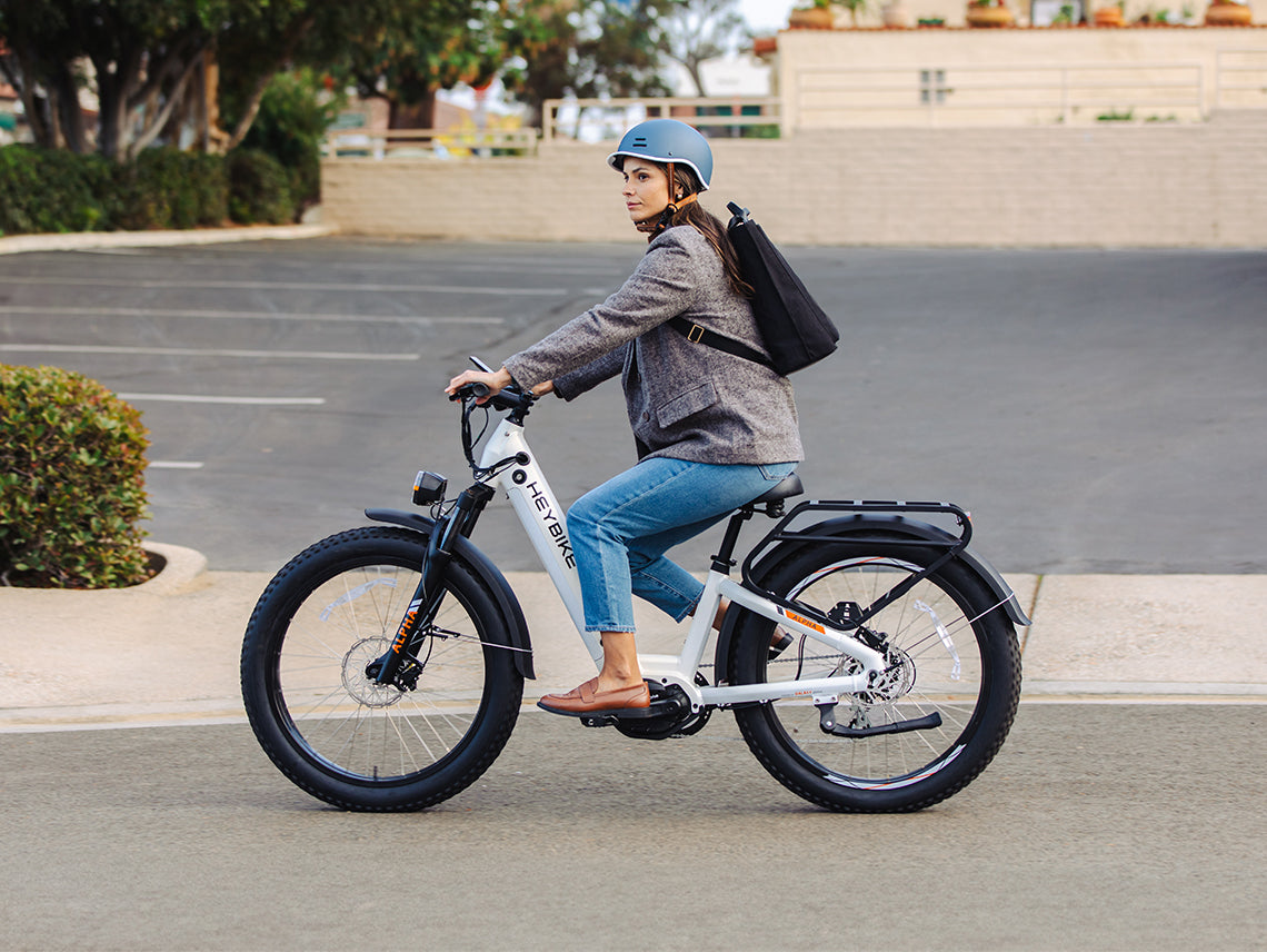 Heybike Alpha 500W mid-drive fat-tire all-terrain electric bike with a torque-plus-cadence sensor, Shimano Altus 8-speed drivetrain, hydraulic disc brakes, 26 by 4 inch fat tires, reinforced aluminum frame in step-through (Pearl White) or step-over (Galaxy Black) configuration, 680Wh battery, and UL 2849 certified electrical system