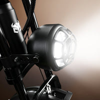 Round LED headlight switched on at the front of the bike