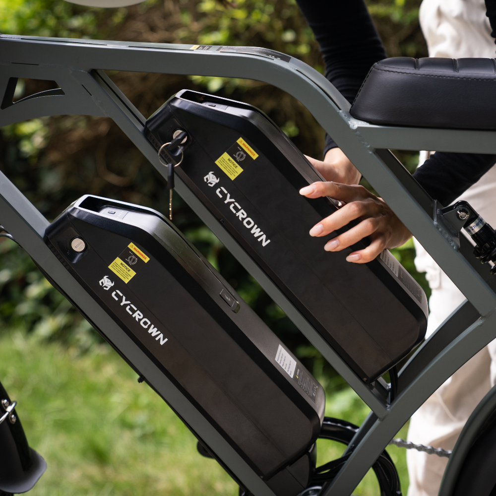 Hand lifting a removable battery from the CycHunter frame