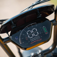 Close-up of the HappyRun G100 Pro motorcycle-style instrument cluster showing the large analog-arc speedometer scale to 60 mph, the digital MPH and KM/H readout, turn-signal arrows, headlight indicator, NFC unlock symbol, battery level bars, and a reverse R indicator
