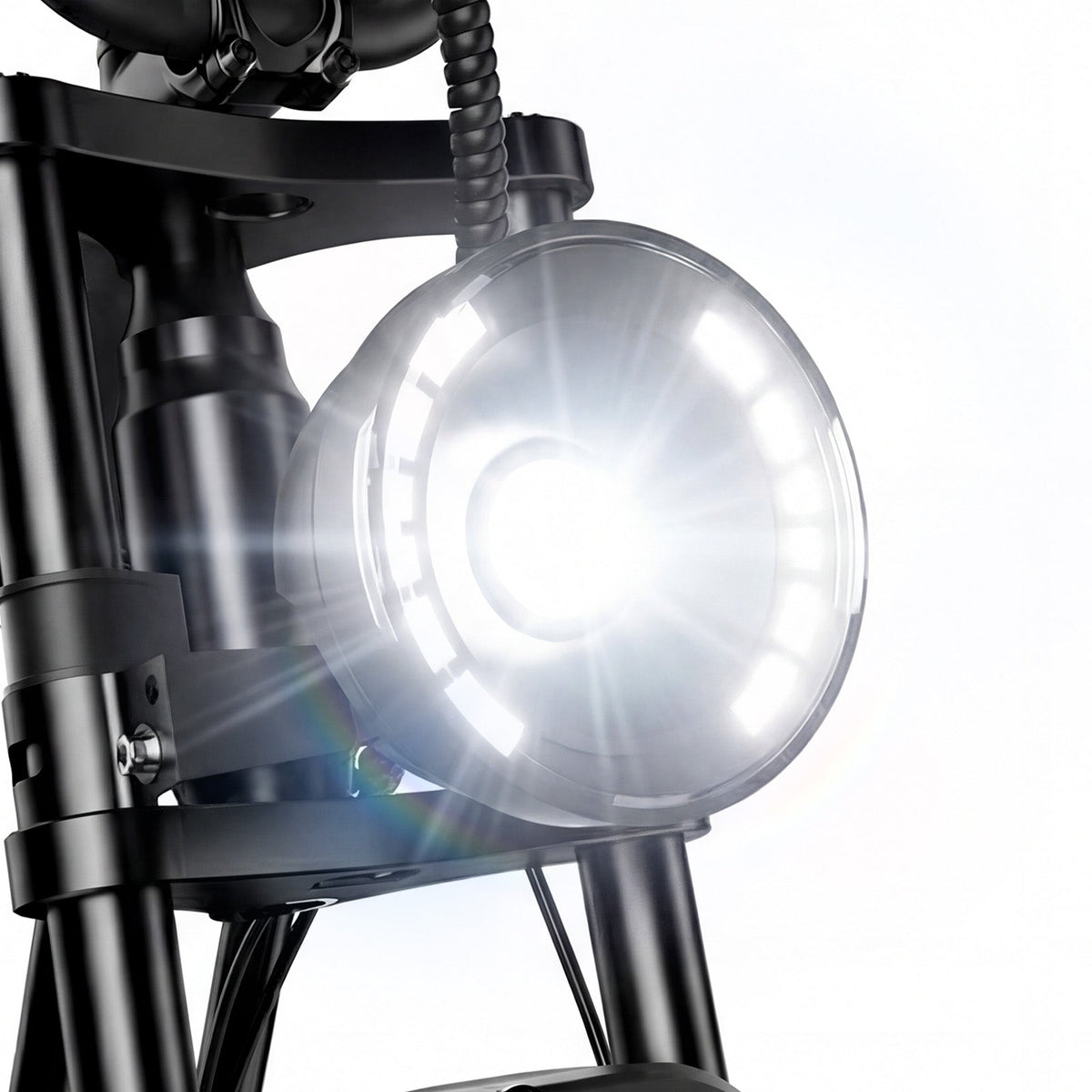 Close-up of the R6 Pro round LED headlight with the inner ring projecting a bright forward beam, mounted on the dual-crown fork