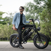 Man standing beside a black CycHunter on a quiet paved path