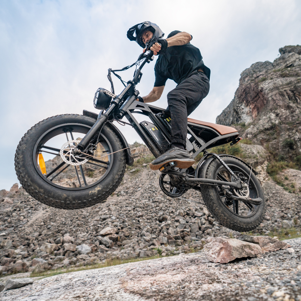 Helmeted rider descending over rocky ground on the CycHunter