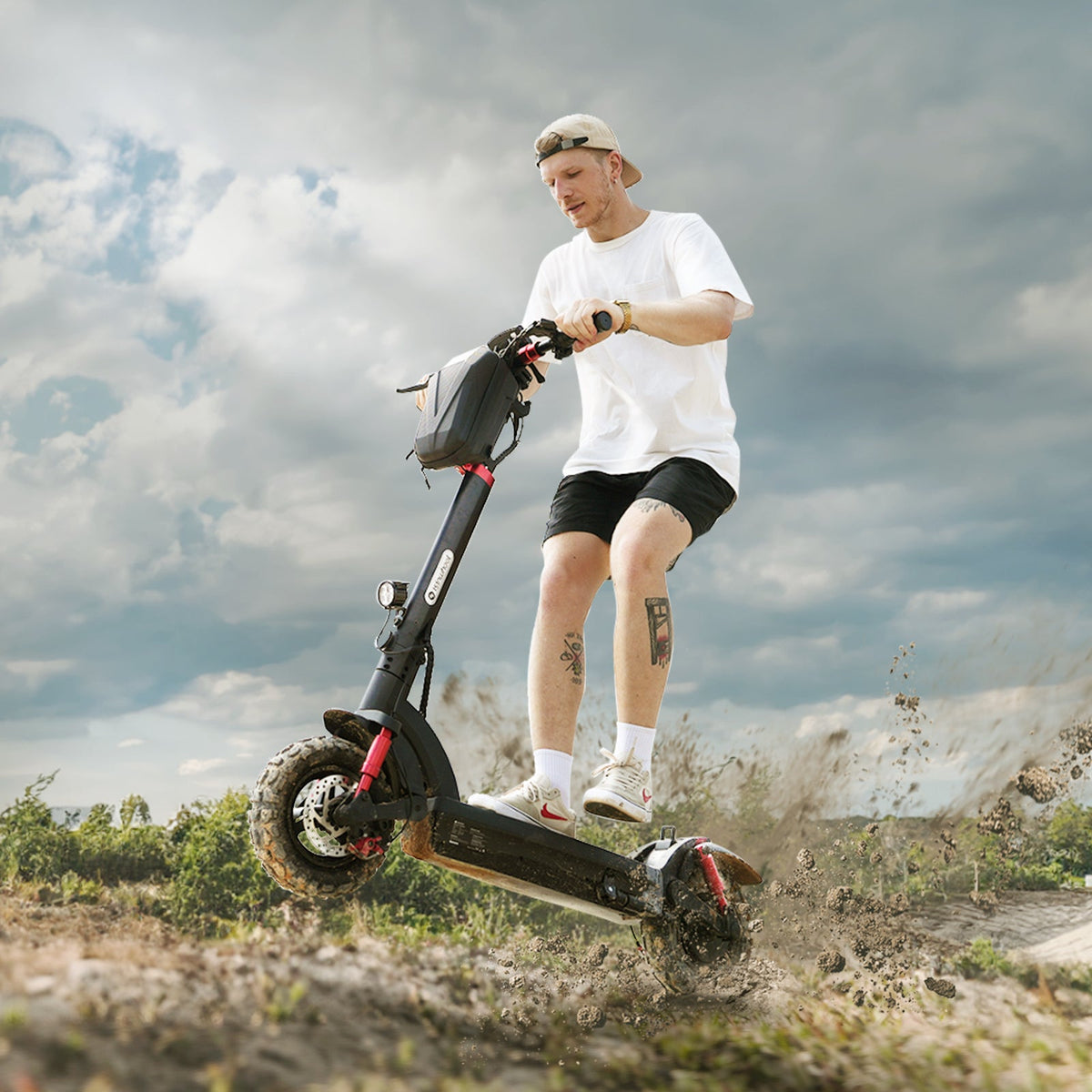 Helmeted rider standing on an isinwheel GT2 while crossing a rocky maintained path