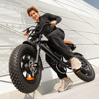 Rider balancing the compact Run Mini beside a modern building