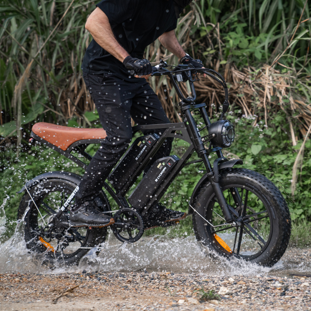 Black CycHunter splashing through a shallow forest stream
