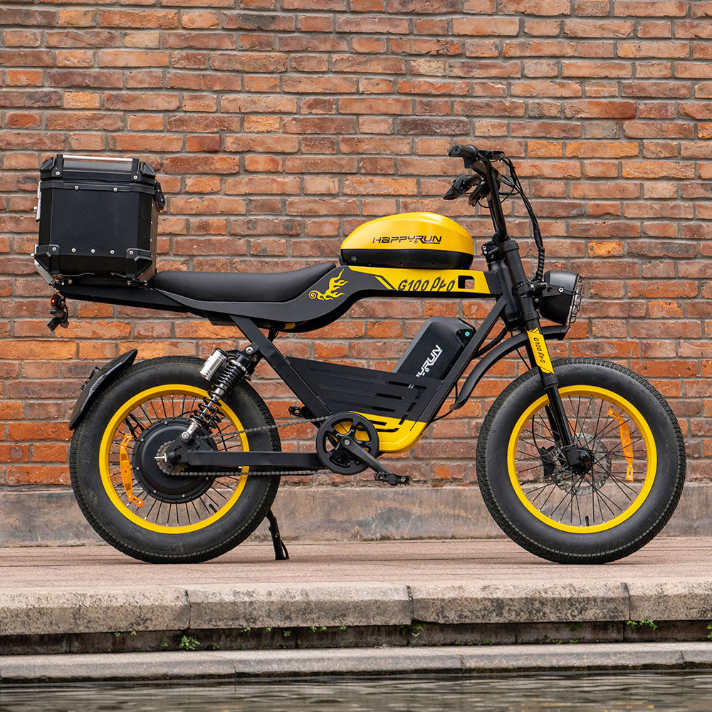 Side profile of the yellow HappyRun G100 Pro Tank parked on a paved road with the yellow rims and tank graphics catching the light