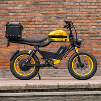 Side profile of the yellow HappyRun G100 Pro Tank parked on a paved road with the yellow rims and tank graphics catching the light