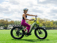 Rider on a Mint Green Velowave Grace 2.0 Step-Thru electric bike in a park