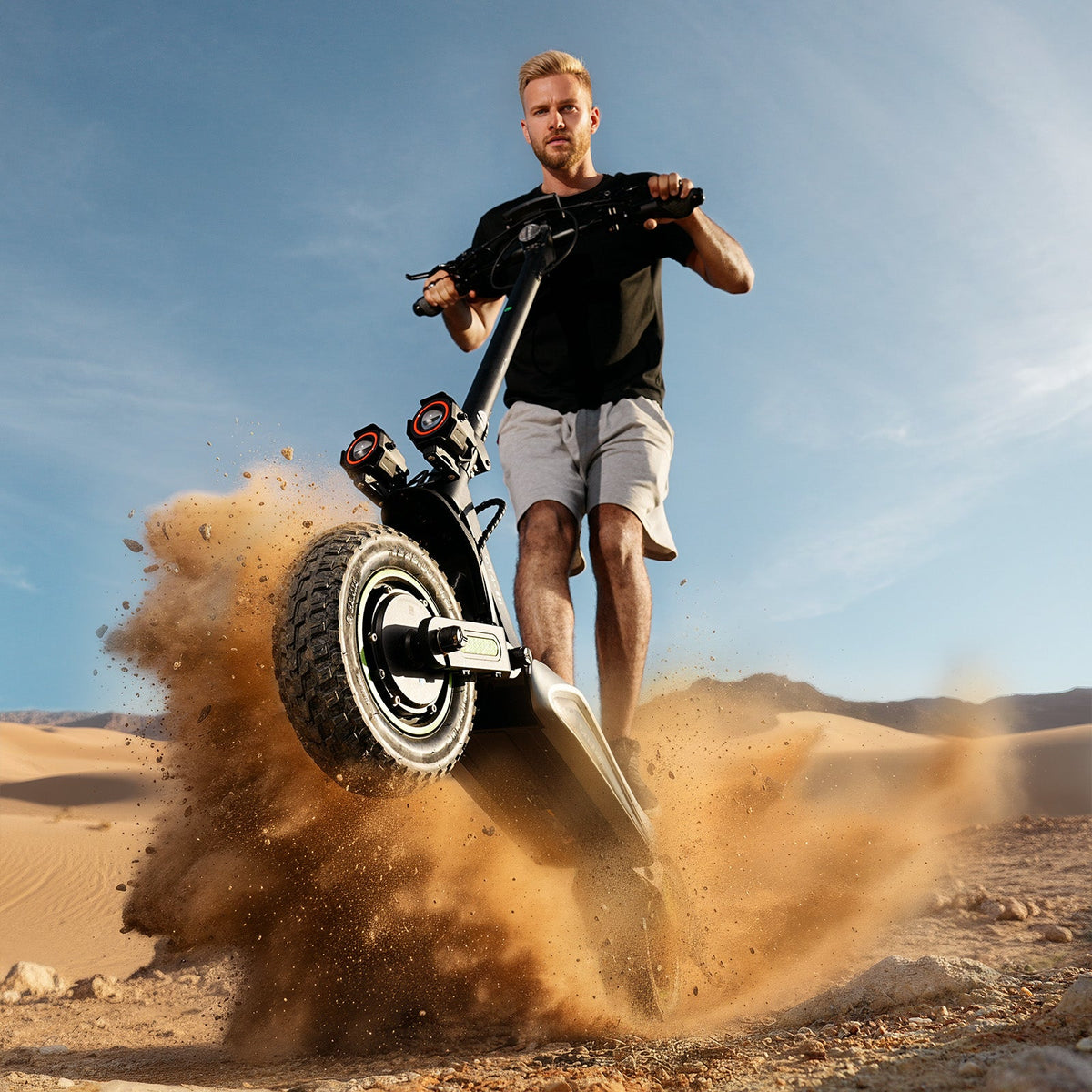 Rider guiding the isinwheel GT4 through loose sand on an open trail