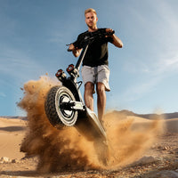 Rider guiding the isinwheel GT4 through loose sand on an open trail