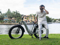 Rider beside a Velowave Ranger Step-Thru 2.0 electric bike at an urban fence