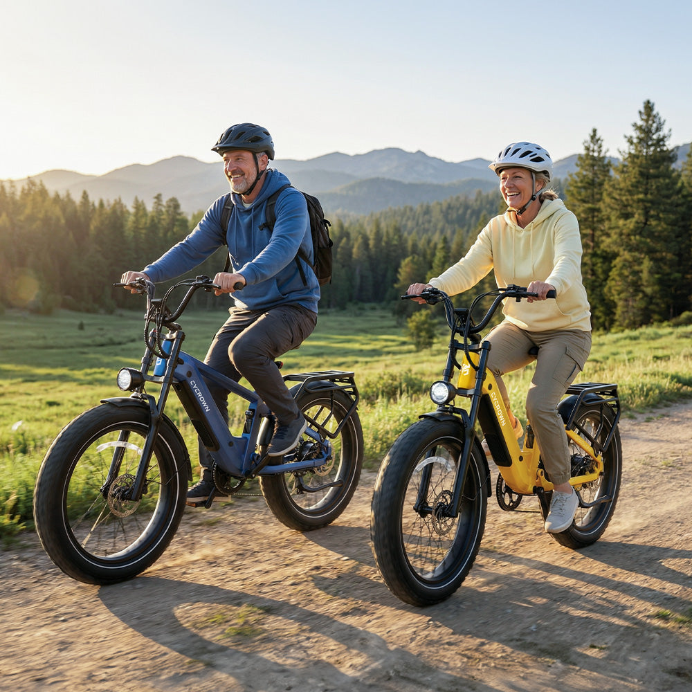 Couple riding blue and yellow Roma e-bikes along a mountain path