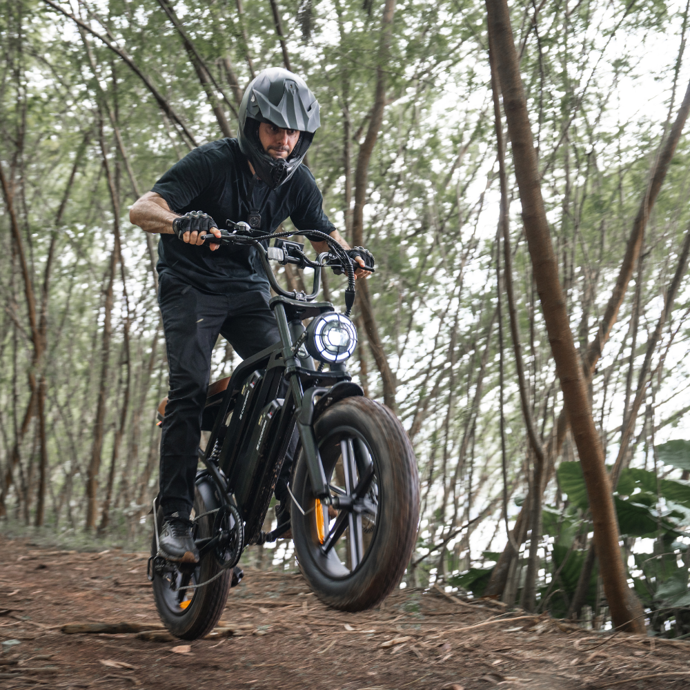Helmeted rider navigating a narrow woodland trail