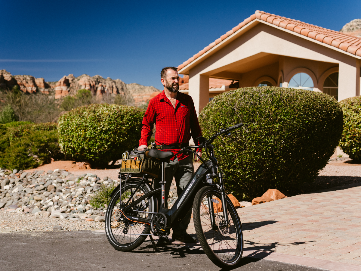 Heybike Hybrid Class 2/3 electric commuter bike with 750W rated rear-hub motor, 27.5 by 2.4 inch KENDA tires, Tektro hydraulic disc brakes, Shimano Altus 8-speed gearing, 6061 aluminum frame, hydraulic front fork, integrated turn-signal lighting, and an 864Wh battery on a UL 2849 certified electrical system