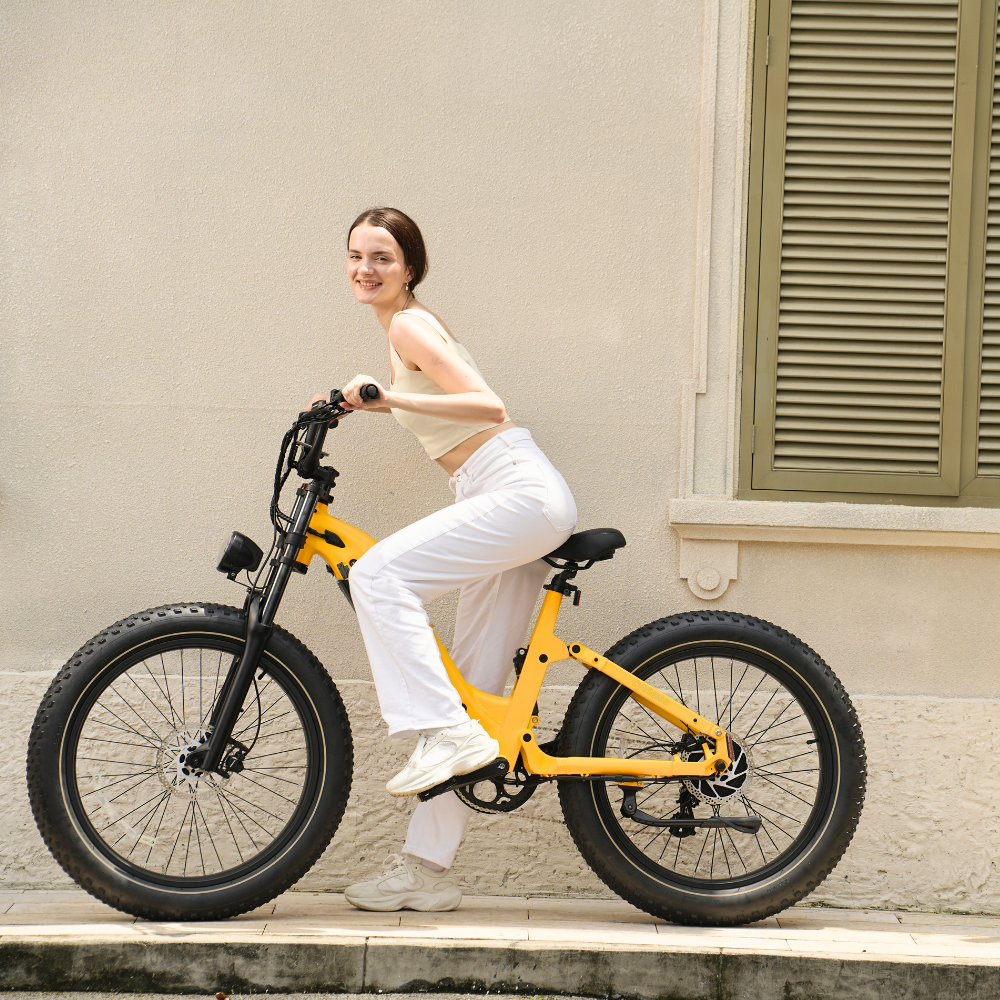 Rider cruising on an amber yellow Roma beside a stucco building