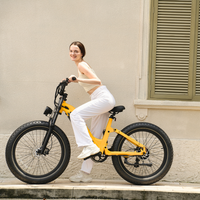 Rider cruising on an amber yellow Roma beside a stucco building