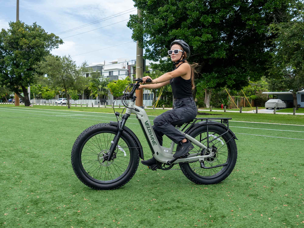 Rider on a Morandi Green Velowave Ranger Step-Thru 2.0 from the rear angle
