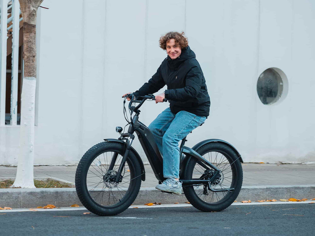 Rider on a dark Velowave Grace 2.0 Step-Thru electric bike on a city street