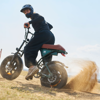 Rider accelerating the Run Mini over a dusty trail