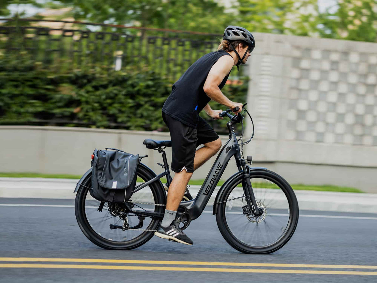 Helmeted rider on a Blue Gray Velowave Breeze T with rear pannier bag