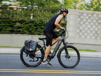 Helmeted rider on a Blue Gray Velowave Breeze T with rear pannier bag