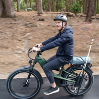Rider taking the alpine green Nomad Pro through a forest path with a relaxed upright posture.