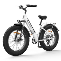 Lunar White isinwheel M60 step-through fat-tire electric bike with dual-LED front lighting, front suspension fork, padded saddle, rear rack with reflector, fenders, 26 by 4 inch fat tires, and 7-speed Shimano-style rear cassette, in front three-quarter studio view
