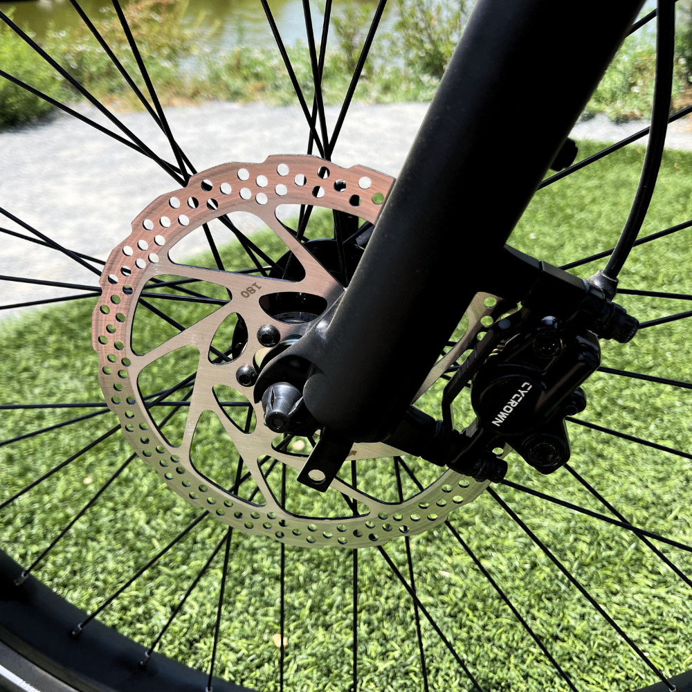 Front hydraulic disc brake rotor and caliper on the Cycrown Dremax commuter e-bike.