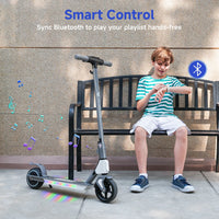 Child using Bluetooth audio beside an illuminated isinwheel S4 scooter