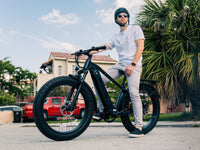 Rider on a silver Velowave Ranger 2.0 fat-tire electric bike outdoors