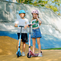 Two helmeted children standing with blue and pink isinwheel S2 scooters