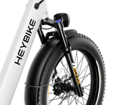Heybike Alpha 500W mid-drive fat-tire all-terrain electric bike with a torque-plus-cadence sensor, Shimano Altus 8-speed drivetrain, hydraulic disc brakes, 26 by 4 inch fat tires, reinforced aluminum frame in step-through (Pearl White) or step-over (Galaxy Black) configuration, 680Wh battery, and UL 2849 certified electrical system