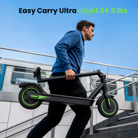 Rider carrying the folded isinwheel S9 Pro up subway stairs beside a passing train, with the isinwheel feature caption highlighting the lightweight design