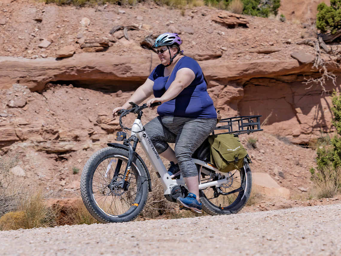 Heybike Alpha 500W mid-drive fat-tire all-terrain electric bike with a torque-plus-cadence sensor, Shimano Altus 8-speed drivetrain, hydraulic disc brakes, 26 by 4 inch fat tires, reinforced aluminum frame in step-through (Pearl White) or step-over (Galaxy Black) configuration, 680Wh battery, and UL 2849 certified electrical system