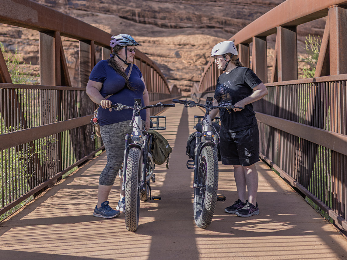 Heybike Alpha 500W mid-drive fat-tire all-terrain electric bike with a torque-plus-cadence sensor, Shimano Altus 8-speed drivetrain, hydraulic disc brakes, 26 by 4 inch fat tires, reinforced aluminum frame in step-through (Pearl White) or step-over (Galaxy Black) configuration, 680Wh battery, and UL 2849 certified electrical system