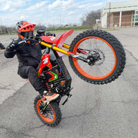 HappyRun F18 motocross-shaped electric dirt bike with a 6000W peak mid-drive motor, 245 Nm of peak torque through a chain drive, knobby off-road tires, full suspension, hydraulic disc brakes with a 190mm rotor, IPX5 water resistance, and a motocross frame in red and black with number plates