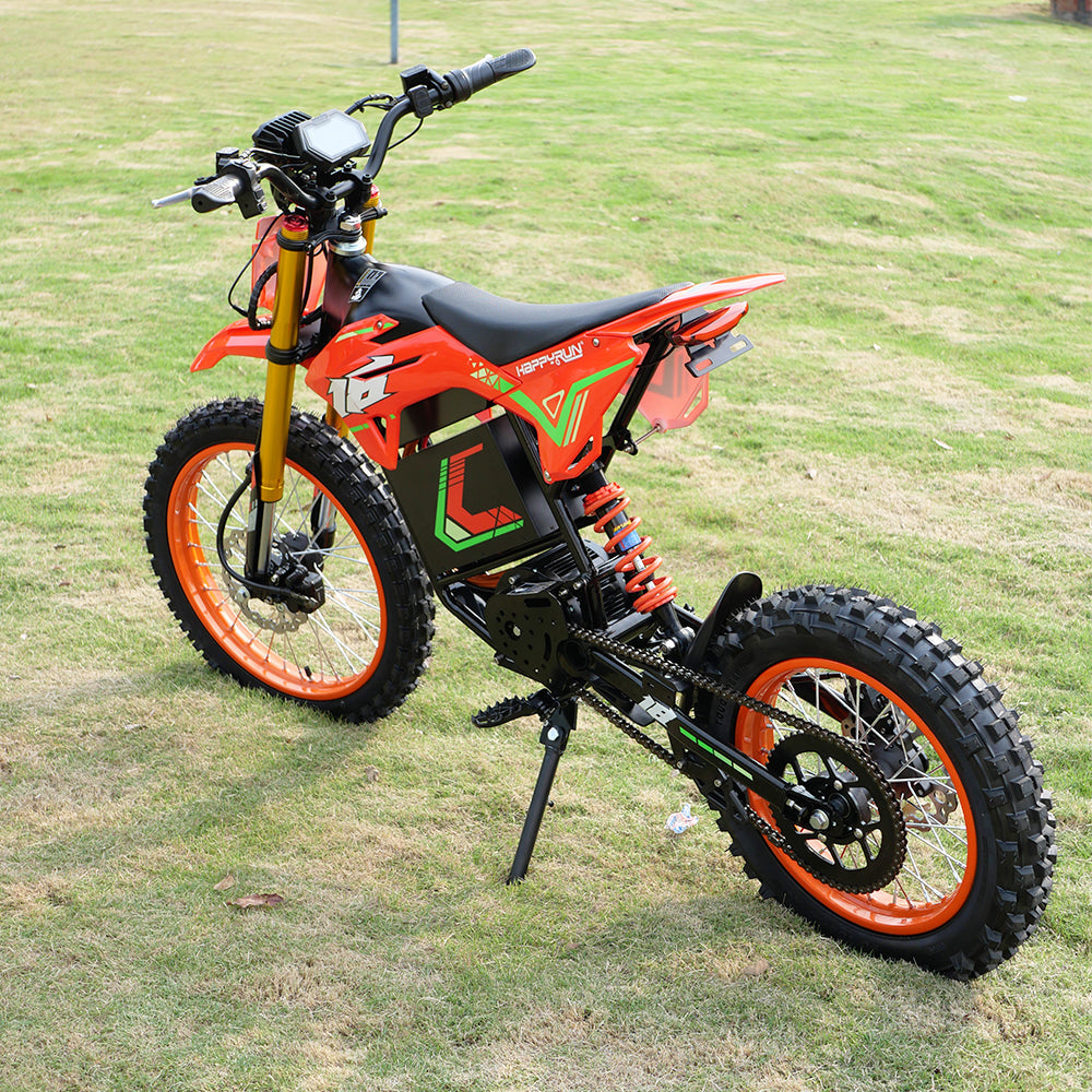 HappyRun F18 motocross-shaped electric dirt bike with a 6000W peak mid-drive motor, 245 Nm of peak torque through a chain drive, knobby off-road tires, full suspension, hydraulic disc brakes with a 190mm rotor, IPX5 water resistance, and a motocross frame in red and black with number plates