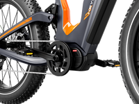 Close-up of the Heybike Hero mid-drive motor mounted at the bottom bracket, showing the torque sensor, the crank arm, the chainring, and the chain routing into the rear derailleur