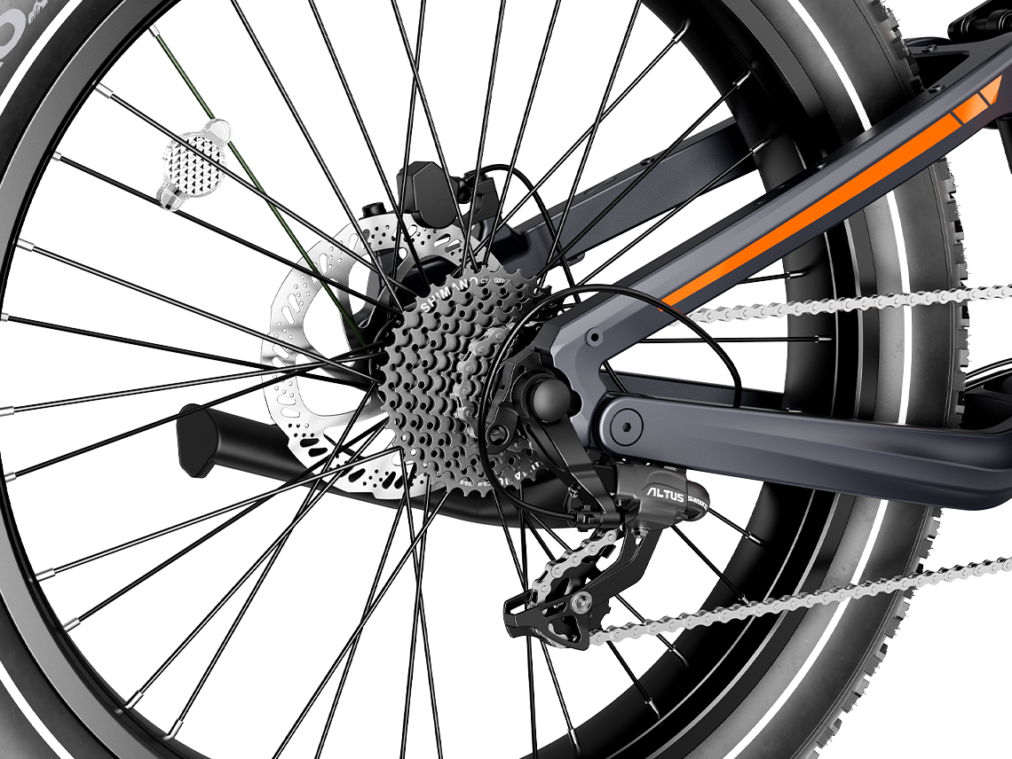 Detail view of the Heybike Hero rear suspension, the rear hydraulic disc brake, the 9-speed cassette, and the chainstay junction on the carbon-fiber frame