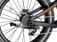 Detail view of the Heybike Hero rear suspension, the rear hydraulic disc brake, the 9-speed cassette, and the chainstay junction on the carbon-fiber frame