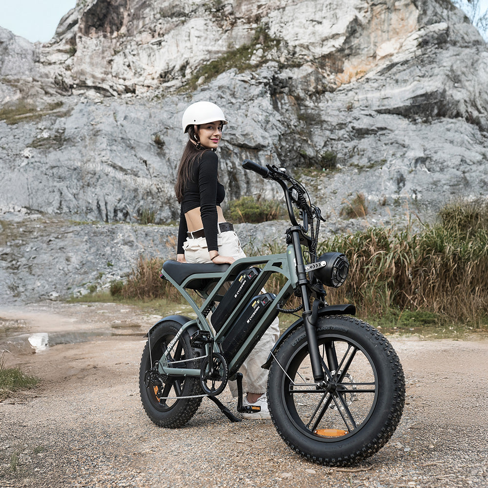 Mint green CycHunter parked on rocky ground with a helmeted rider