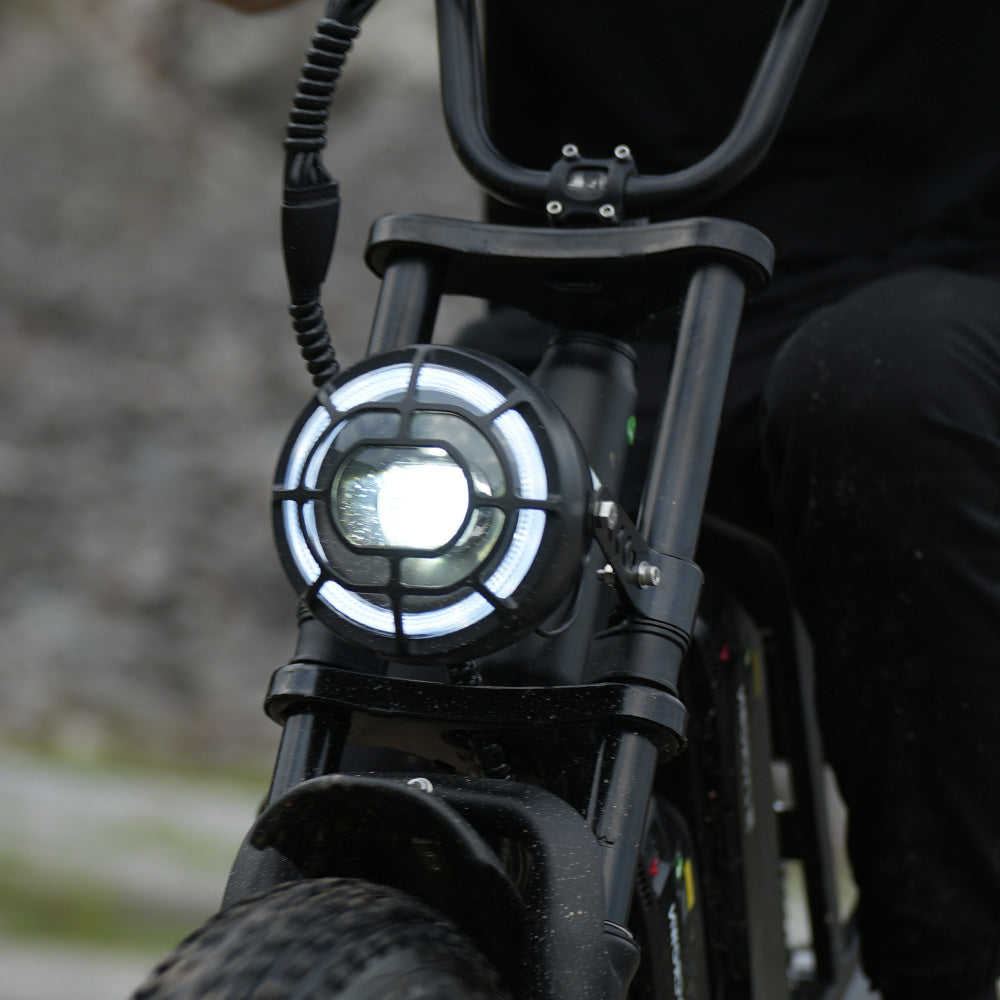 Round CycHunter LED headlight illuminated in daylight