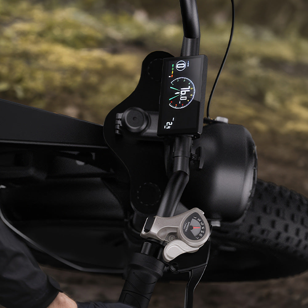 Front suspension adjustment control beside the headlight