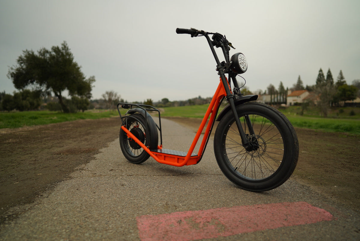 Orange EUNORAU JUMBO parked on a paved lane in a front three-quarter view