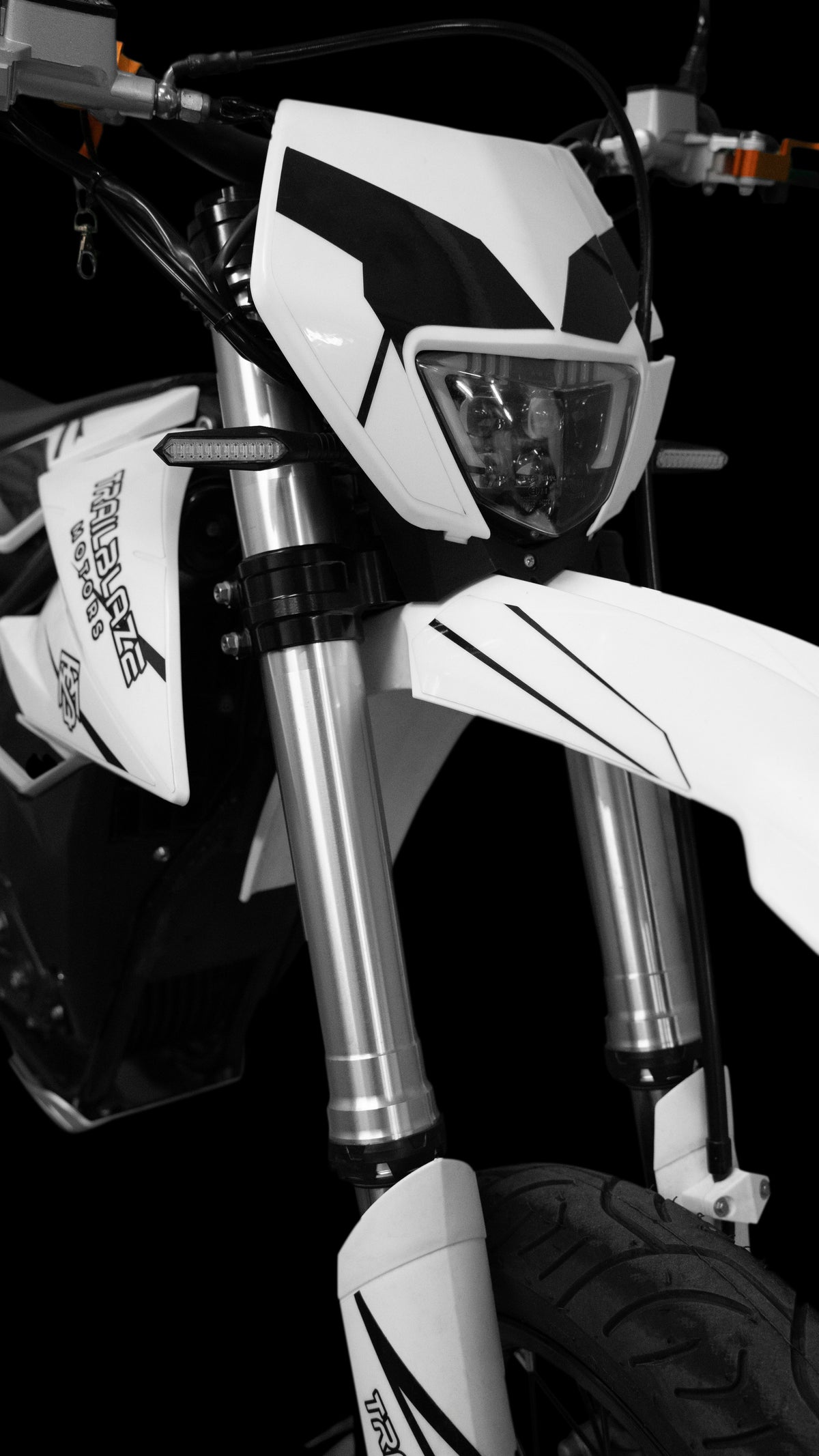Trailblaze Motors Omega SM front fork, headlight, and fender detail